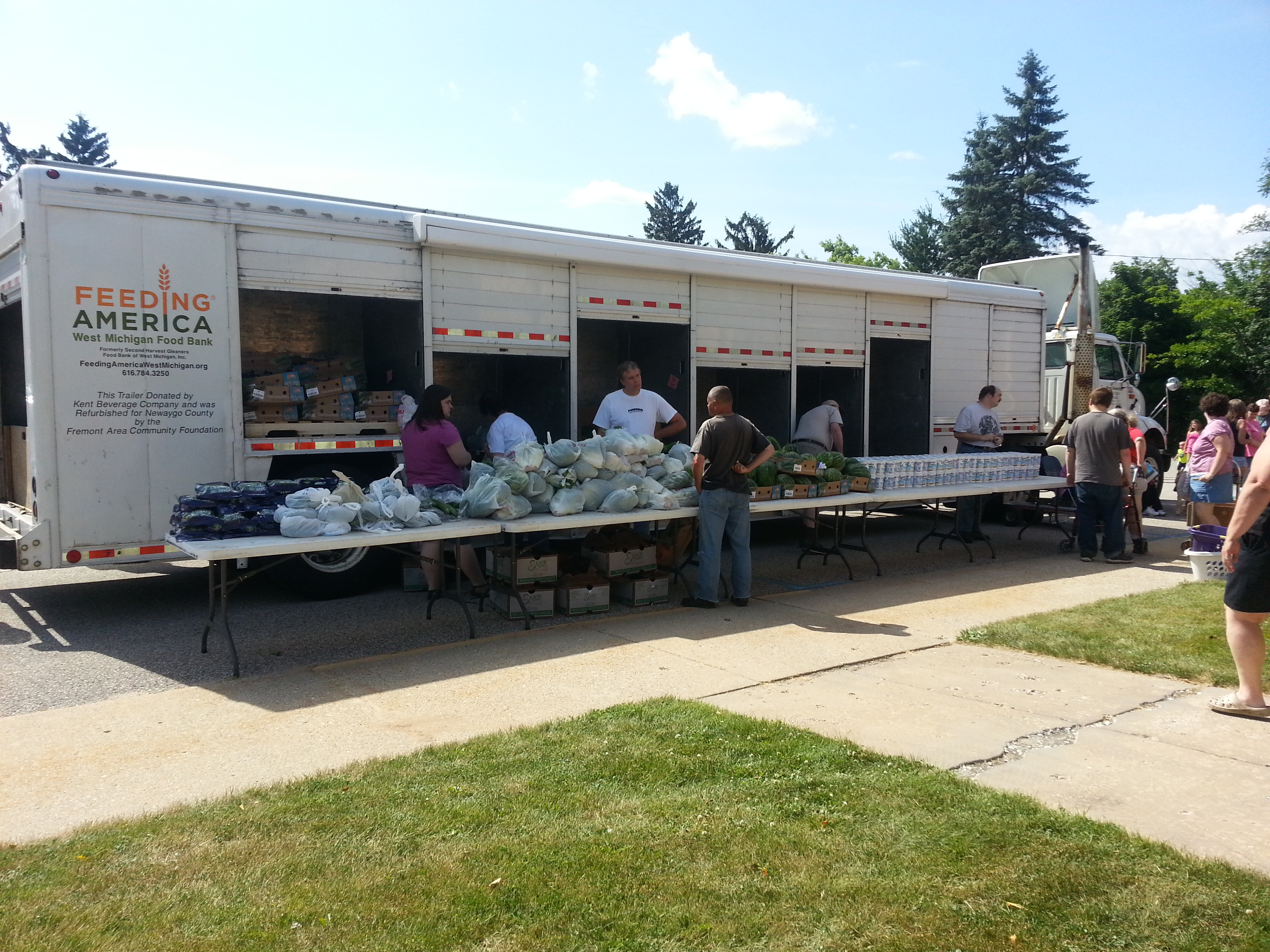 mobile food truck volunteers passing out food